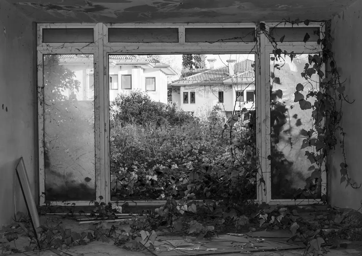 Casa colonial antigua con estructura de madera en deterioro progresivo, mostrando signos de abandono y paso del tiempo