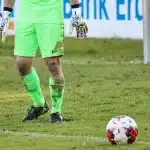 Arquero atajando un penal en una tanda de penales durante un partido de fútbol.
