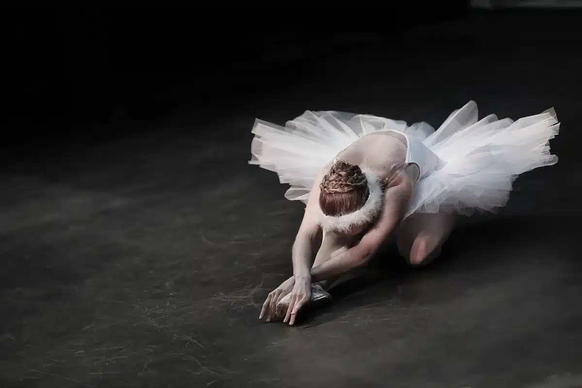 Presentación de danza contemporánea en escena con iluminación teatral profesional